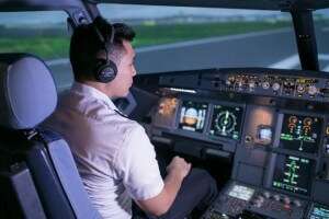a pilot trainee using flight simulator