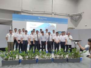 a group picture of graduated pilots and their instructors on stage